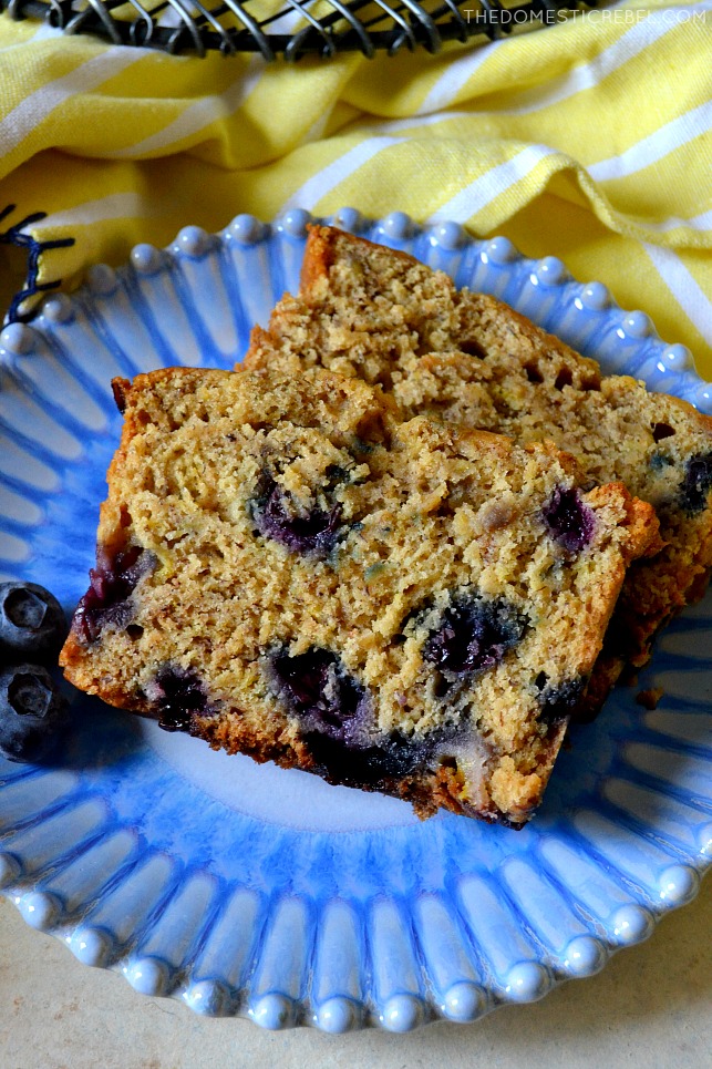 blueberry banana bread sliced on blue plate with yellow fabric