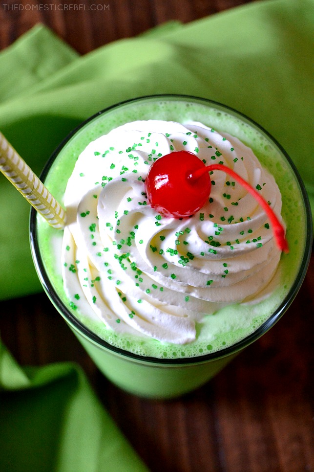 view from above of copycat shamrock shake with straw and cherry and green fabric