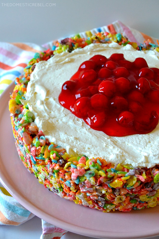 fruity pebbles cheesecake on pink cake stand