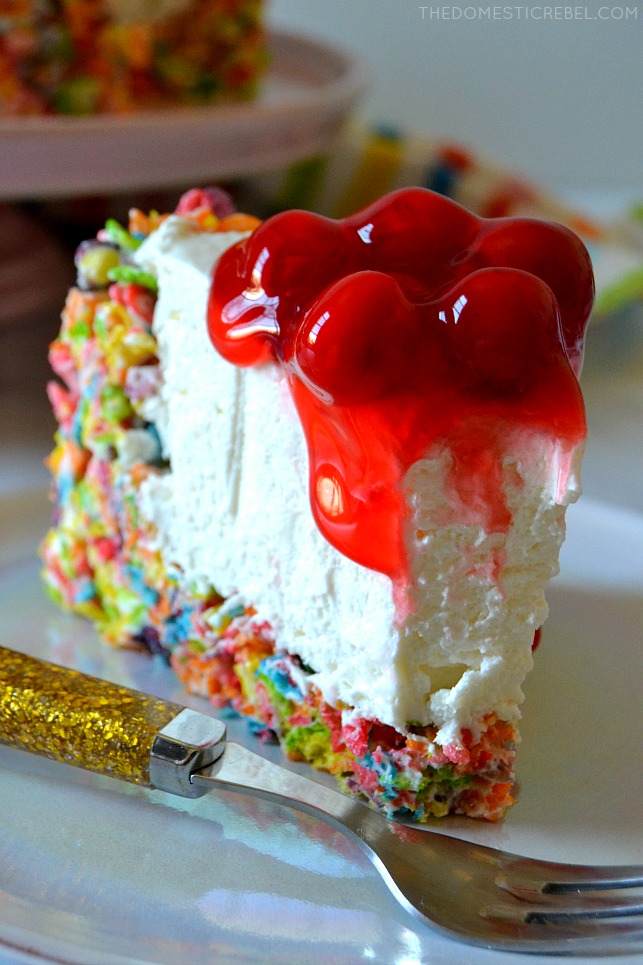 This No-Bake Fruity Pebbles Cheesecake is HEAVEN! A Fruity Pebbles Krispy Treat crust is filled with a deliciously creamy no-bake cheesecake and topped with cherry pie filling. Easy, unique and so scrumptious! 