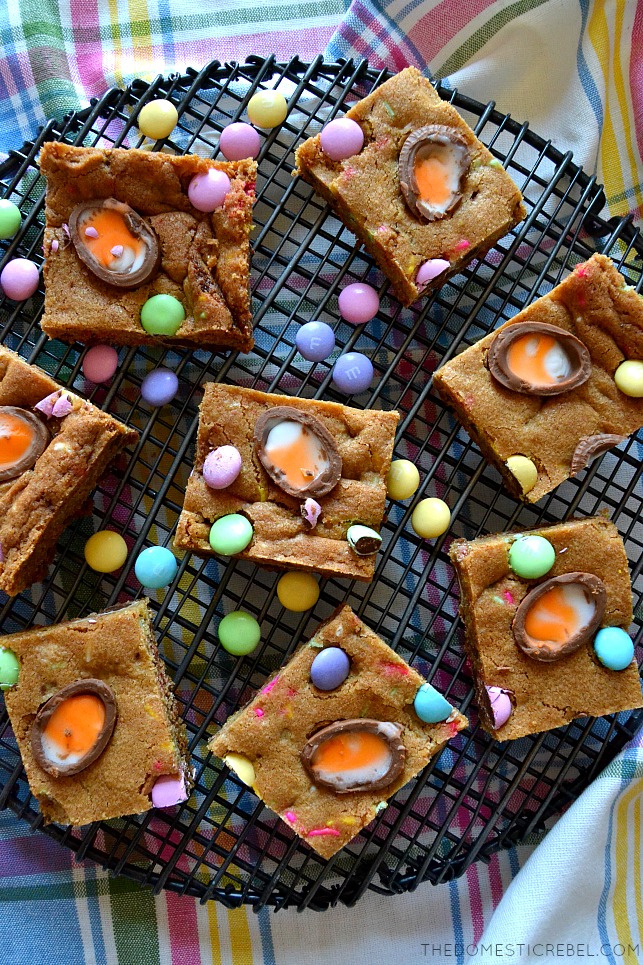 cadbury easter egg blondies arranged on wire rack with easter candies scattered