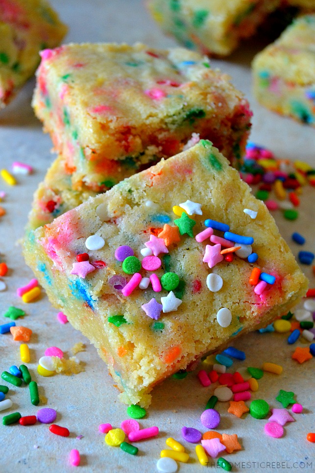 a small stack of cake batter blondies on wood with sprinkles