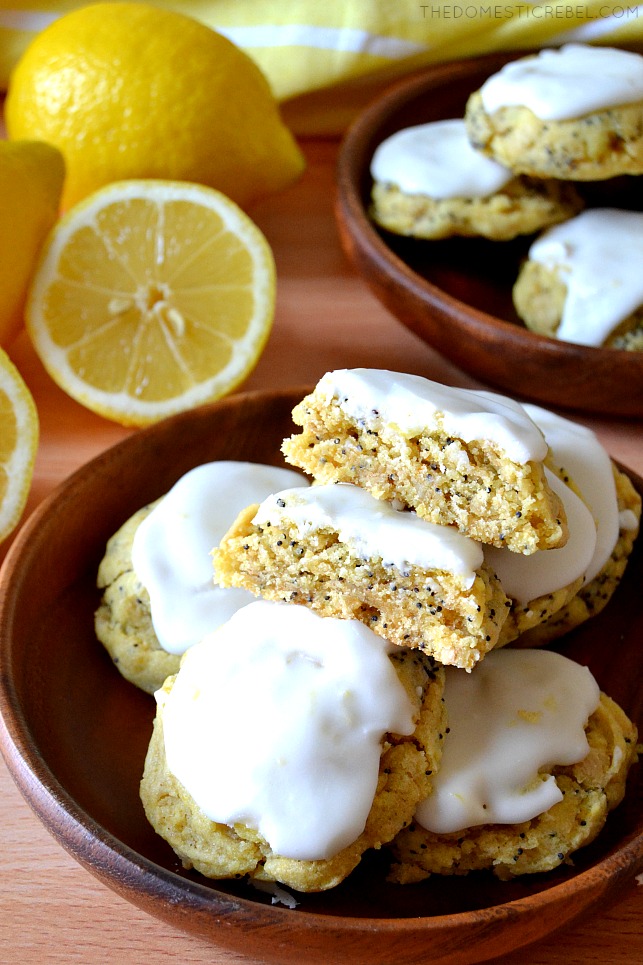 lemon poppyseed cookies on wooden plates with lemons
