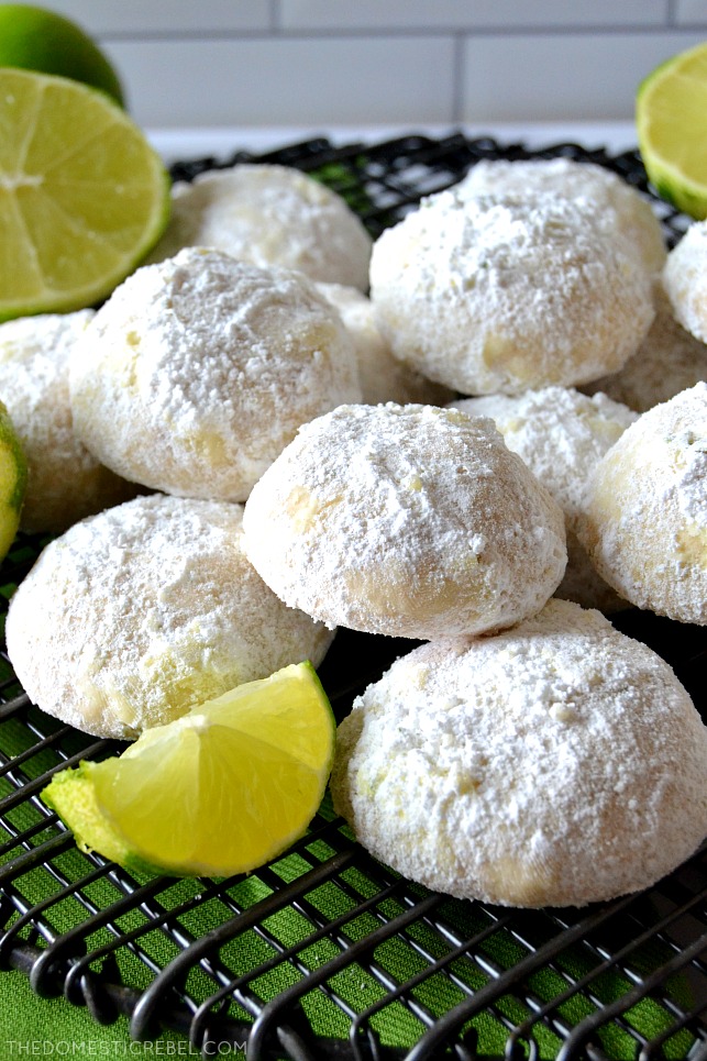 key lime cooler cookies piled on wire rack with limes