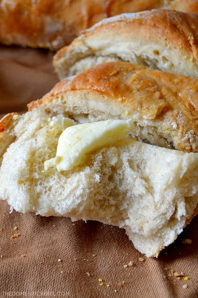 torn french bread slice with butter