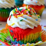 Rainbow Cupcake on white background with sprinkles