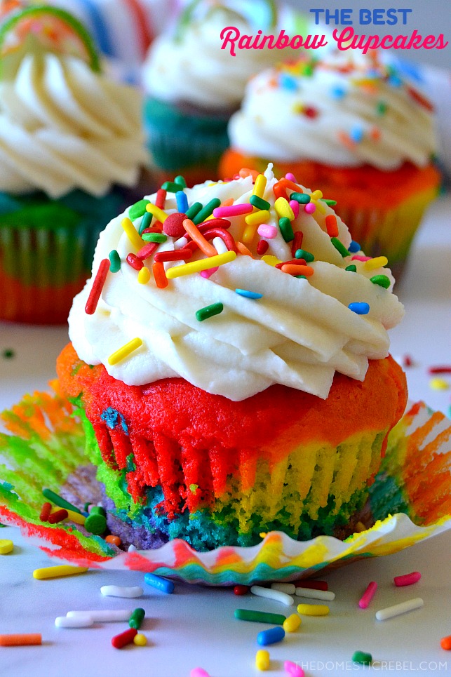 Best Ever Rainbow Cupcakes on white background with peeled wrapper and sprinkles