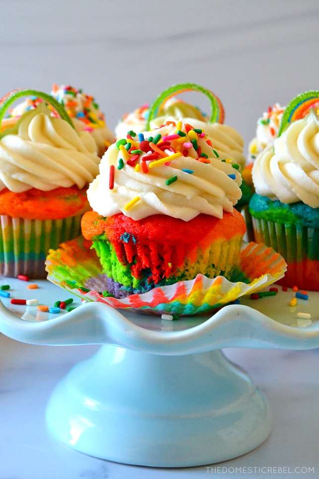Rainbow Cupcakes arranged on blue cake stand