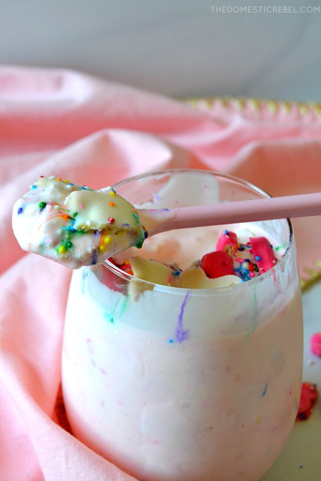 Circus Animal Cookie Blizzard with pink spoon resting on glass and pink fabric