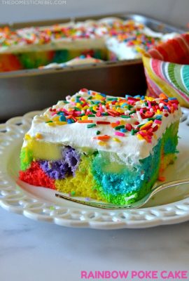 Rainbow Poke Cake on white plate with fork