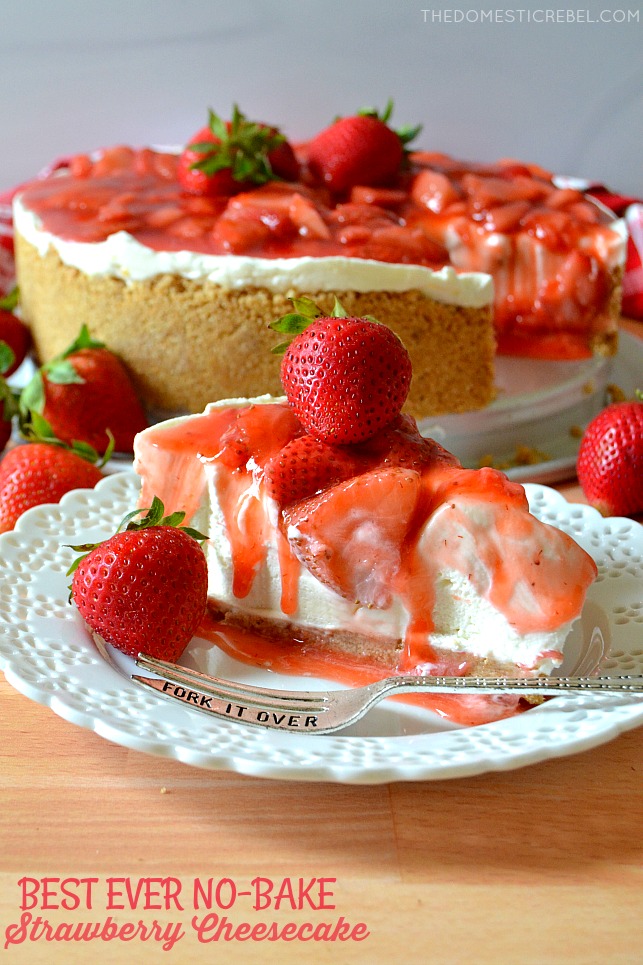 Strawberry Cheesecake on white plate with fork and fresh berries