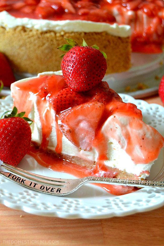 Close up of Strawberry Cheesecake slice on white plate with silver fork