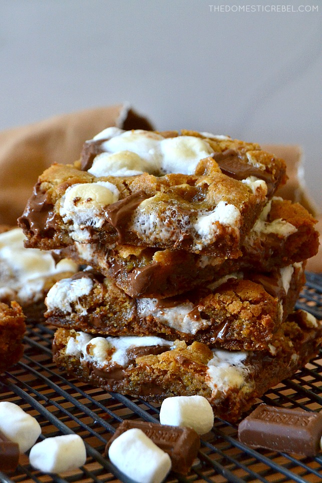 stack of s'mores cookie bars with marshmallows and hershey bars on wire rack