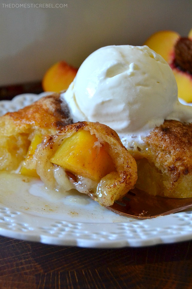 Peach Dumplings on white plate with a bite on a fork