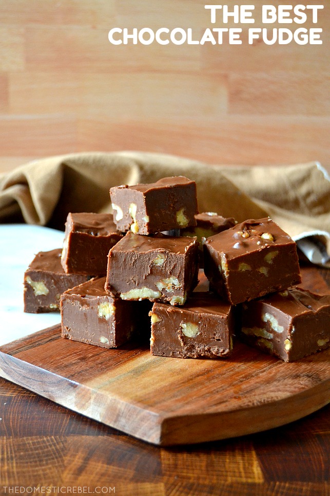 Small pile of chocolate walnut fudge pieces on a wooden and marble board