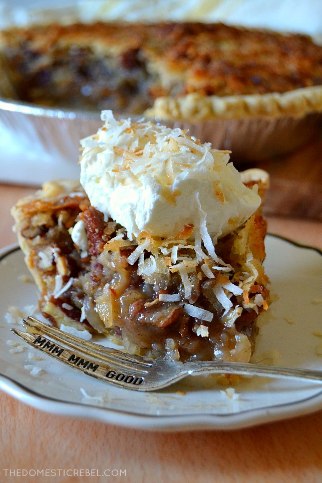 Slice of coconut pecan pie with fork on a white plate