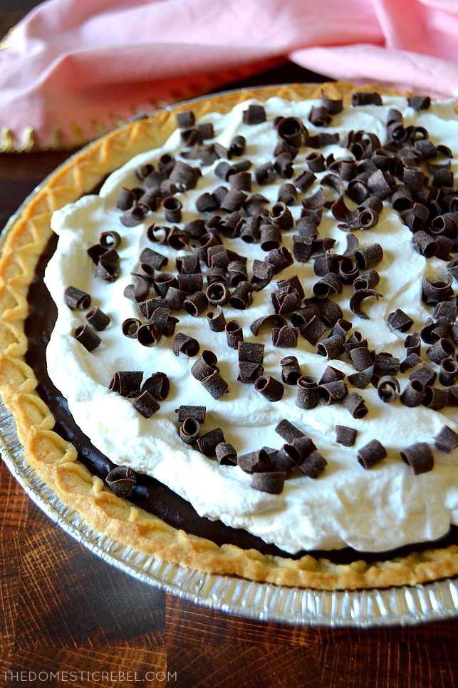 Chocolate cream pie in a pie pan with a pink towel