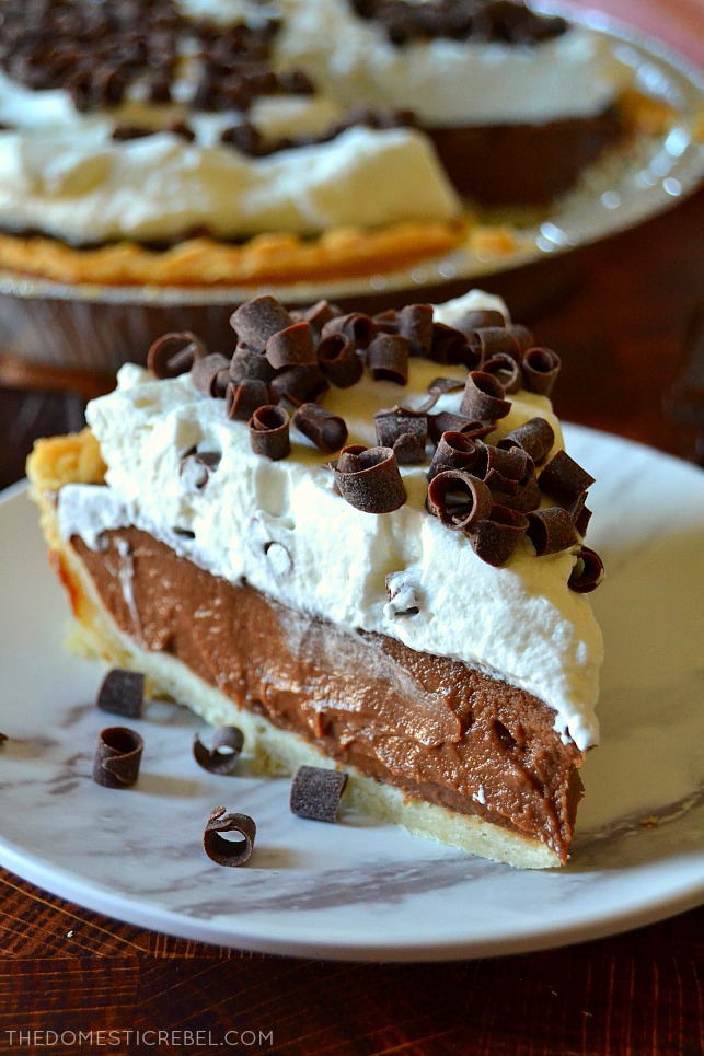 Closeup slice of chocolate cream pie on a white plate