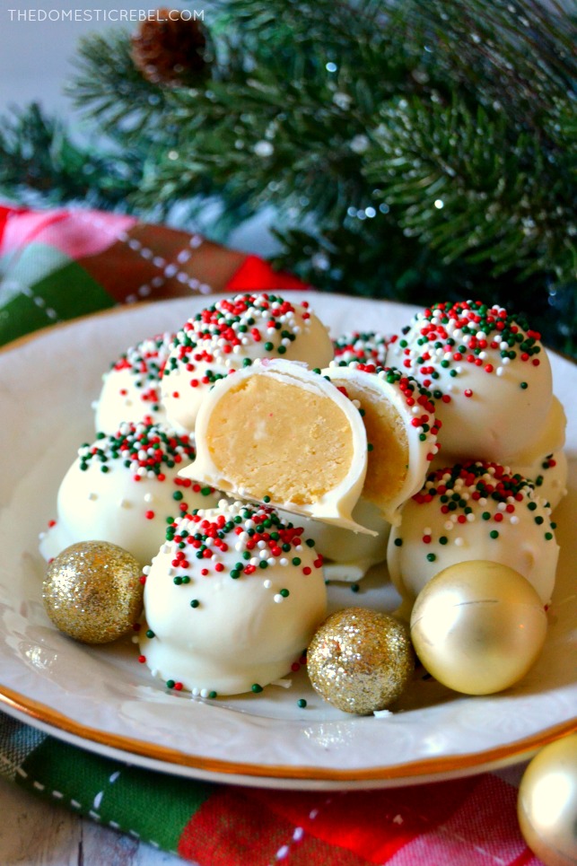 Plate of sugar cookie truffles on a white plate with greenery in background