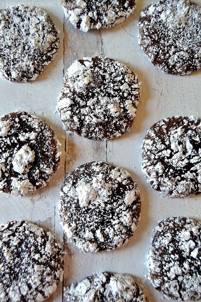 Arrangement of brownie crackle cookies on a white wood board