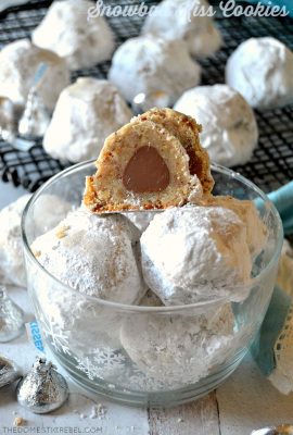 Snowball Kiss Cookies arranged in a clear plastic bowl