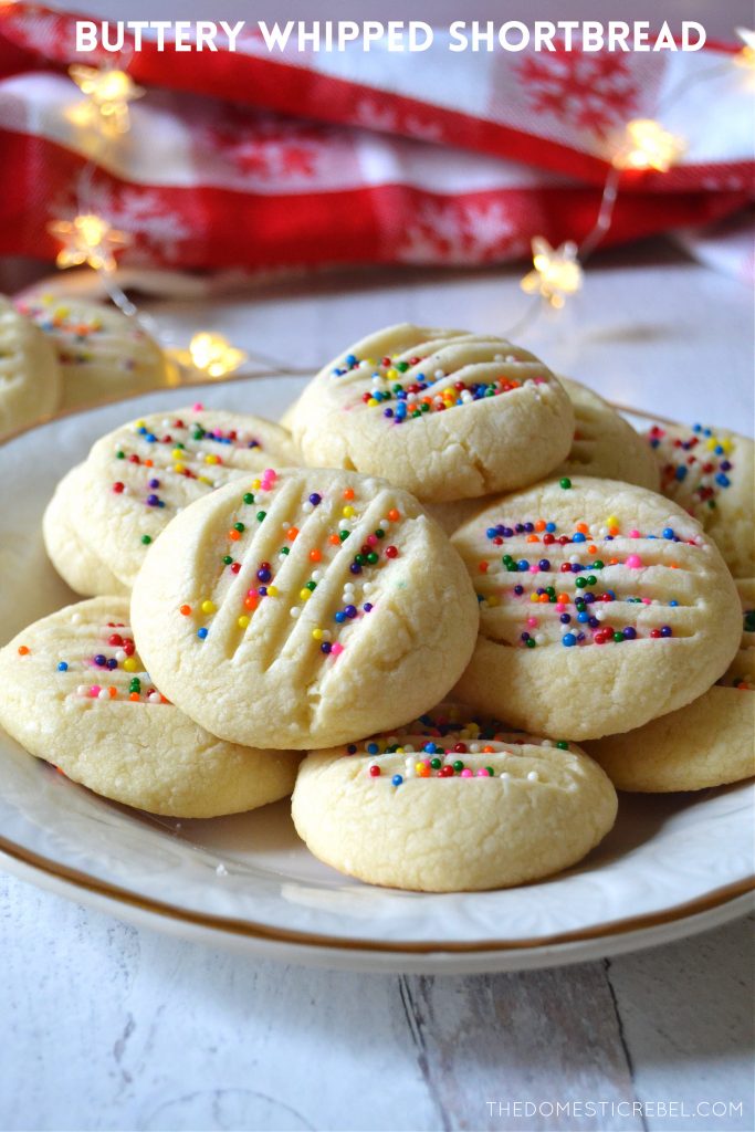 A white and gold plate filled with buttery whipped shortbread cookies