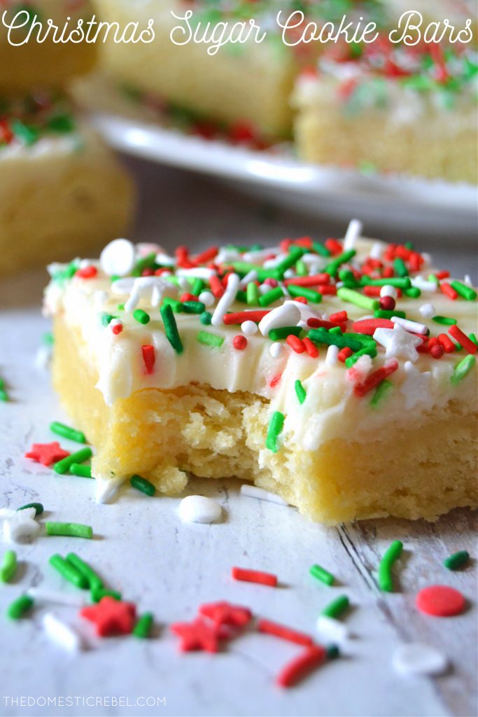 Photo of a bitten Christmas Sugar Cookie Bar surrounded by sprinkles