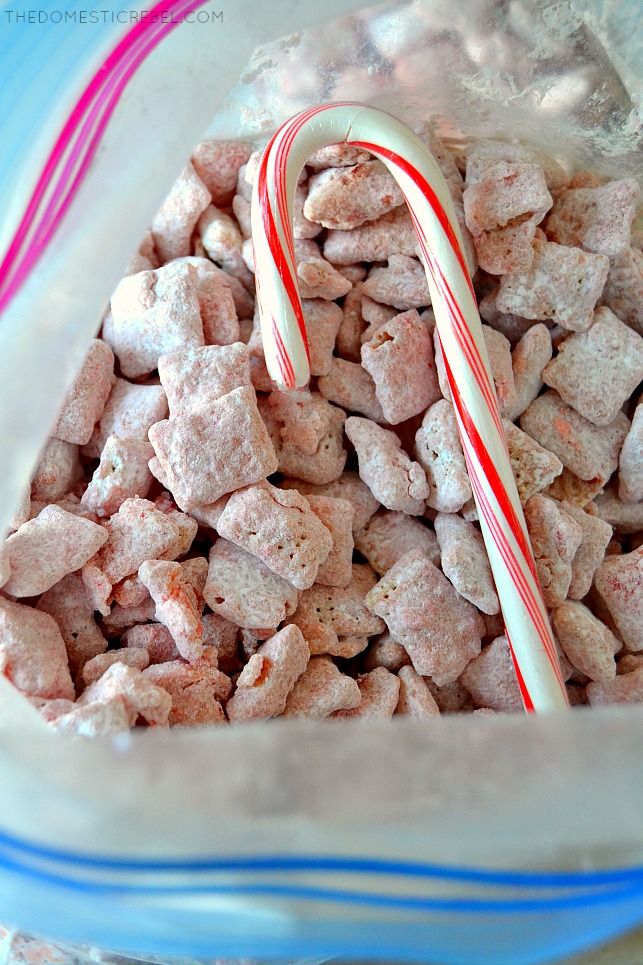 Peppermint candy cane muddy buddies in a bag with a candy cane