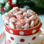 peppermint candy cane muddy buddies in a red dot bowl