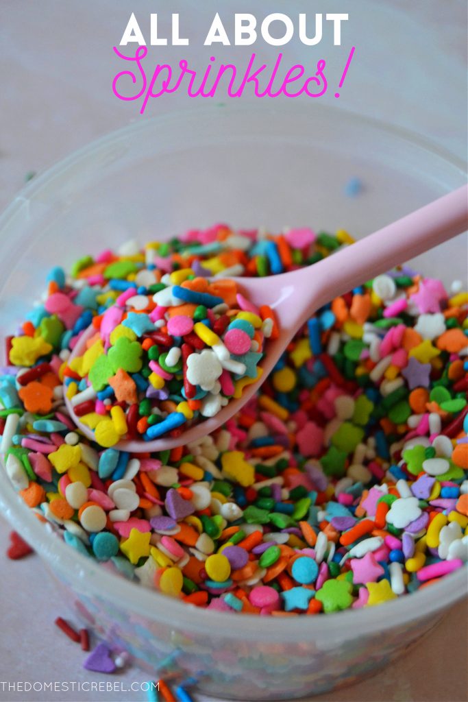 closeup of a rainbow sprinkle blend in a bowl with a pink spoon