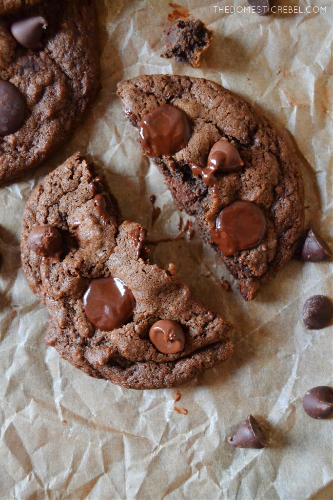 a chocolate chocolate chip cookie split open on parchment