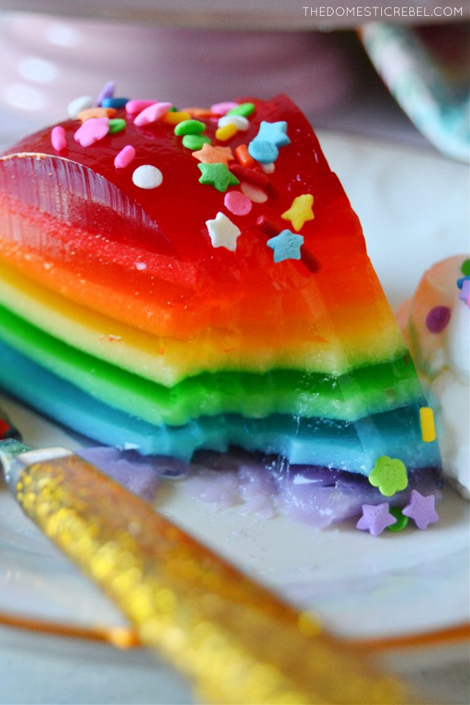 Closeup of rainbow jello mold slice with a bite missing