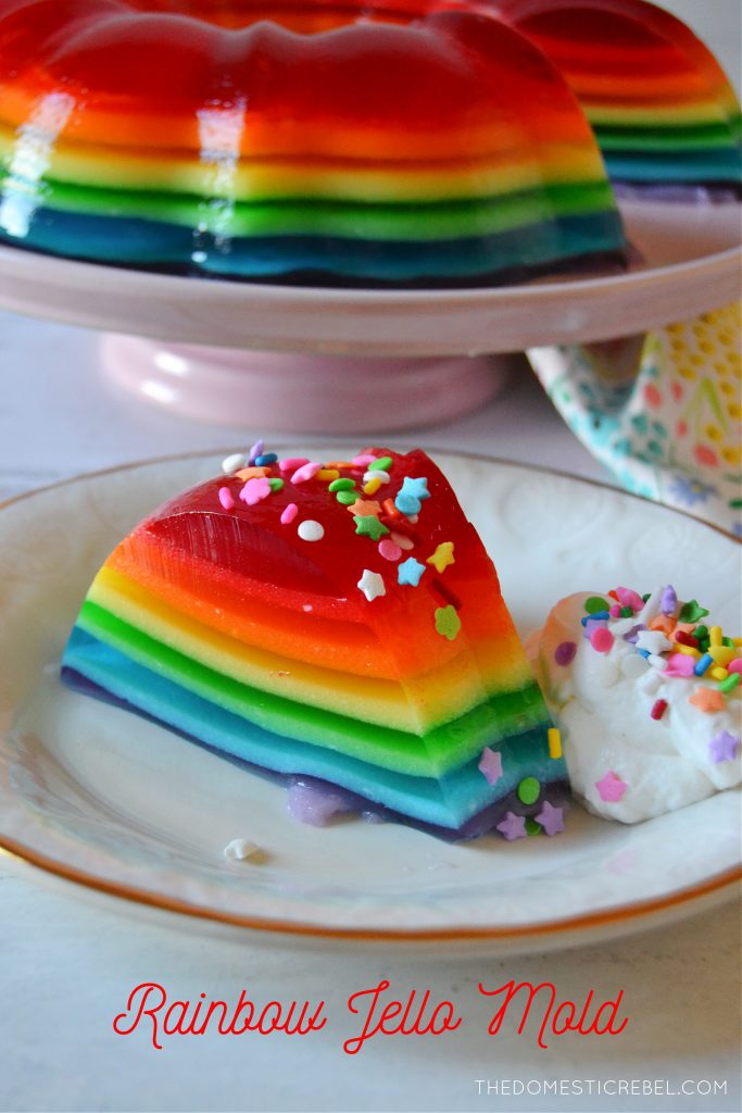 Rainbow Jello Mold slice on a plate with jello ring in the background