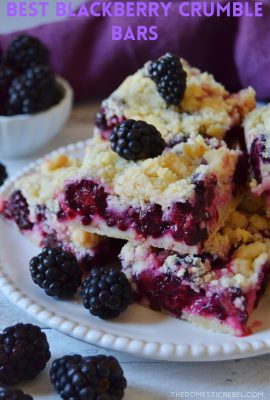 blackberry crumble bars arranged on a white plate