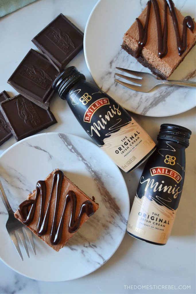 An arrangement of Bailey's mousse brownies with chocolate squares and mini bottles of Bailey's