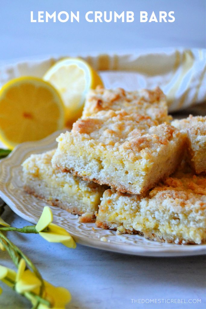 lemon crumble bars arranged on a white plate with lemons in background