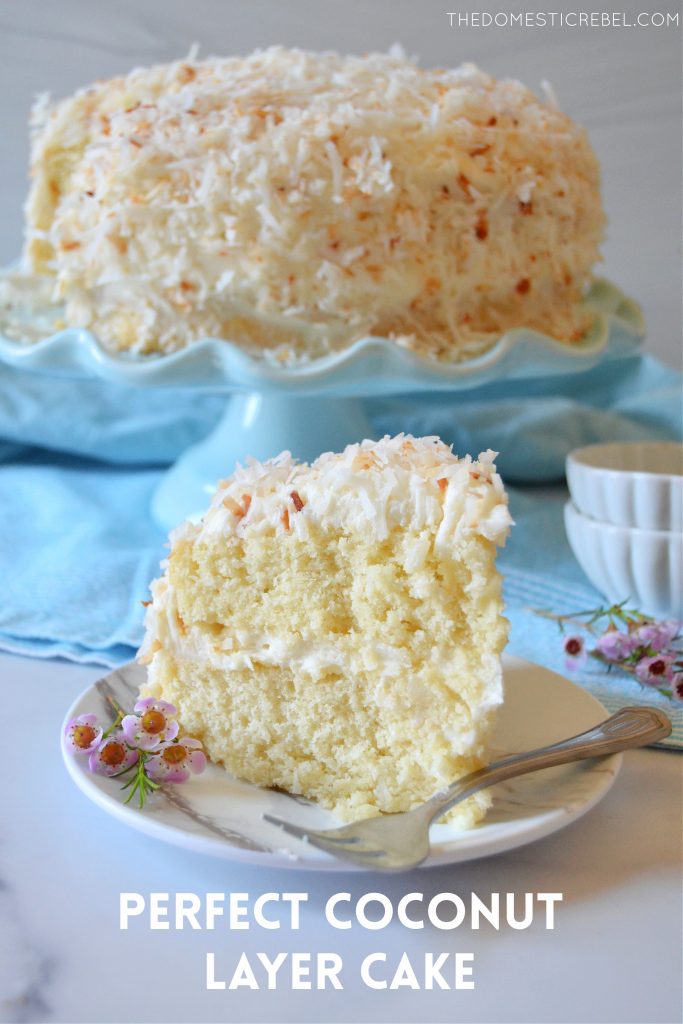 coconut layer cake slice on a white plate with flowers and a fork