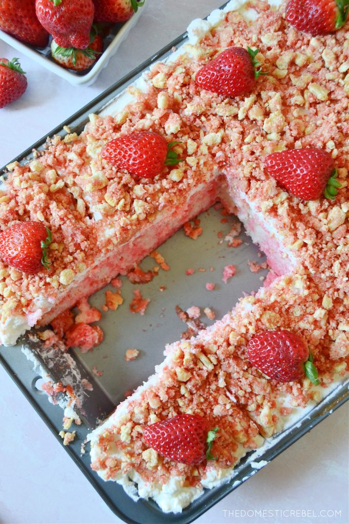 a pan full of strawberry crunch poke cake slices