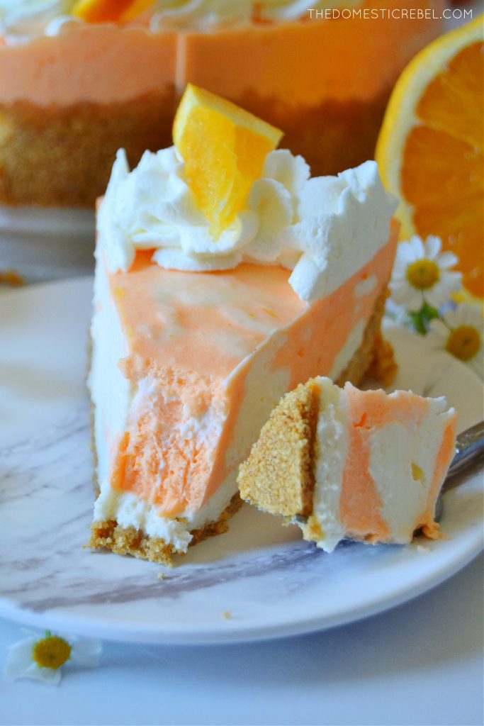 photo of orange creamsicle cheesecake with a bite missing