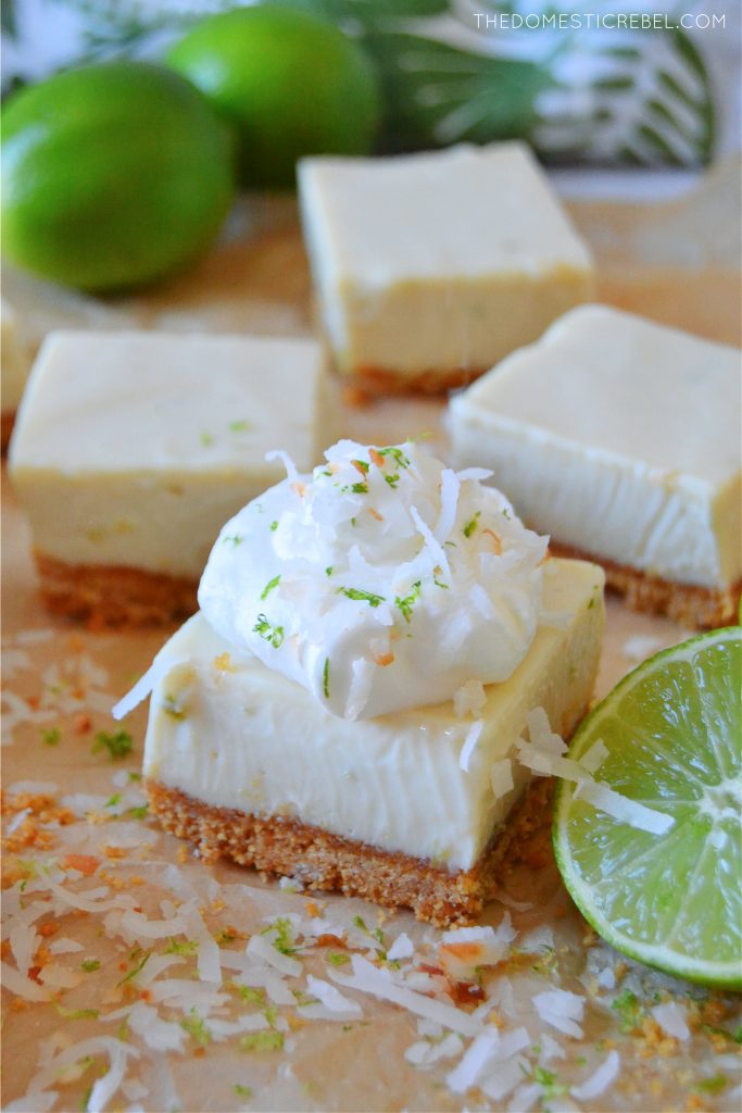 key lime pie bar with whipped cream and lime zest on top 