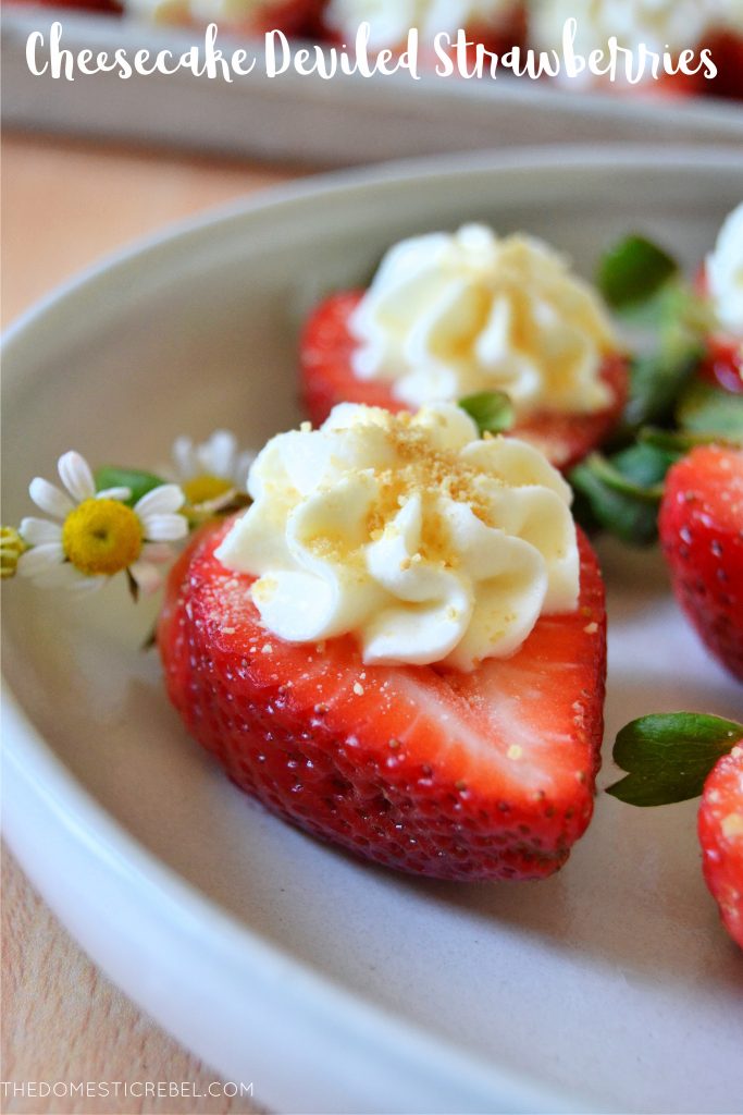 a cheesecake deviled strawberry on a white plate with a daisy