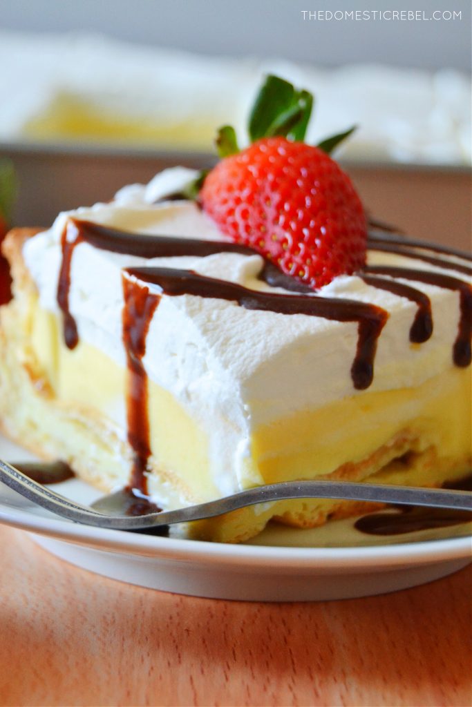 closeup slice of cream puff cake on a white plate