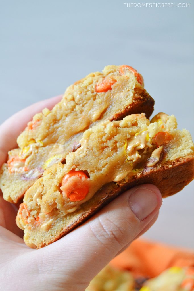 a closeup of the author holding a split open peanut butter cookie