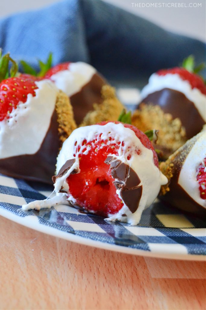 closeup of a bitten s'mores dipped strawberry