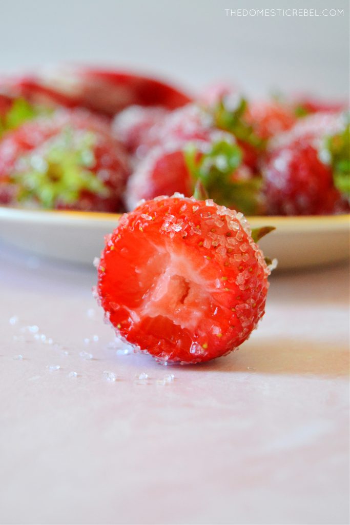 closeup of a rosé strawberry with a bite missing