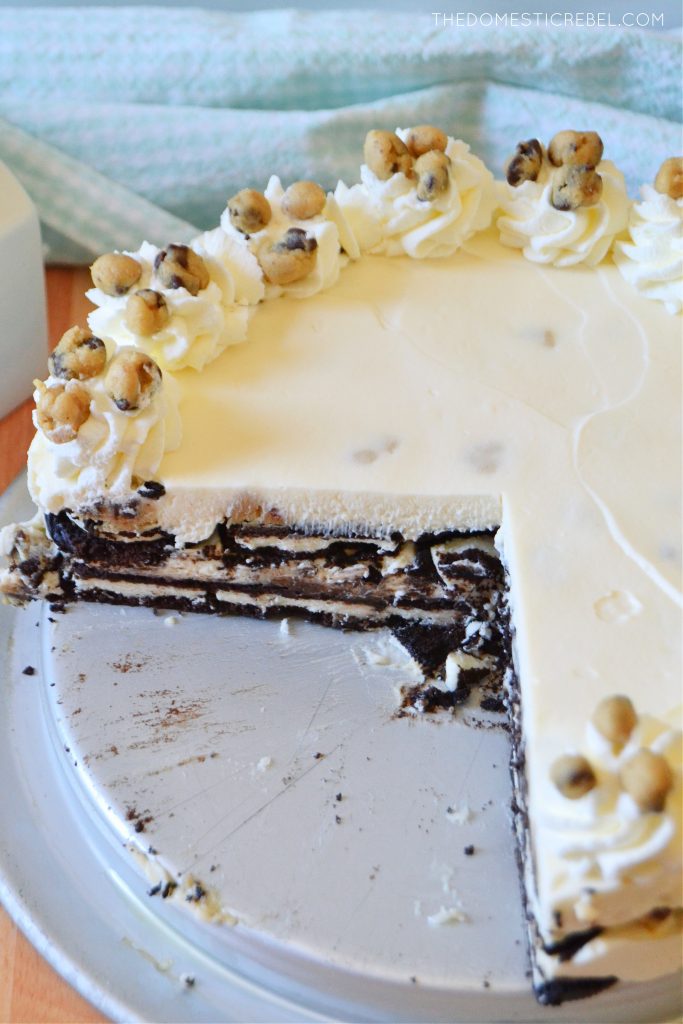 cookie dough oreo icebox cake in the pan with a giant slice cut out