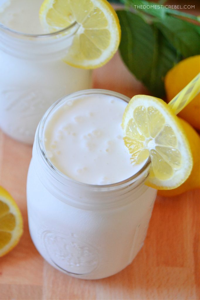 An aerial shot of Frosted Lemonade in a mason jar with a lemon wedge