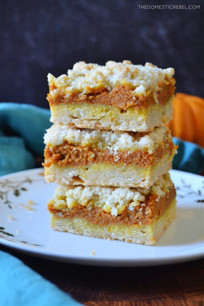 a trio stack of pumpkin pie crumble bars on a white plate