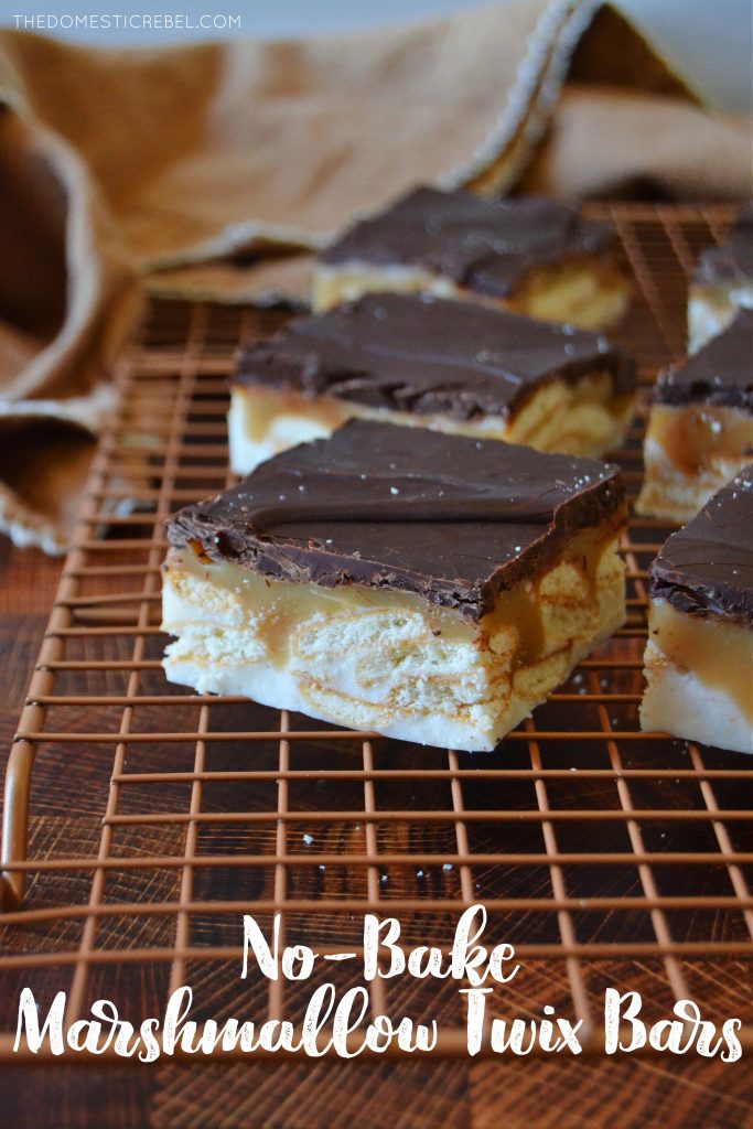 twix no-bake marshmallow bars on a gold wire rack with a towel