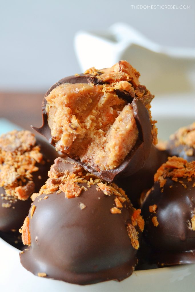 closeup of a nutter butter butterfinger truffle with a bite missing 